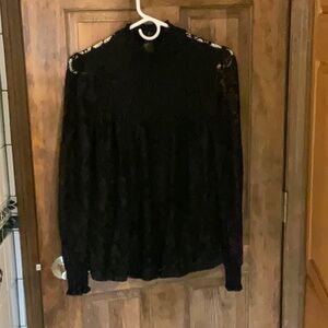 Long sleeve lace blouse size small with black lining and bell sleeves.